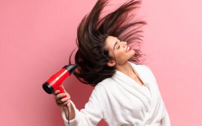 a girl drying her hair with hair dryer