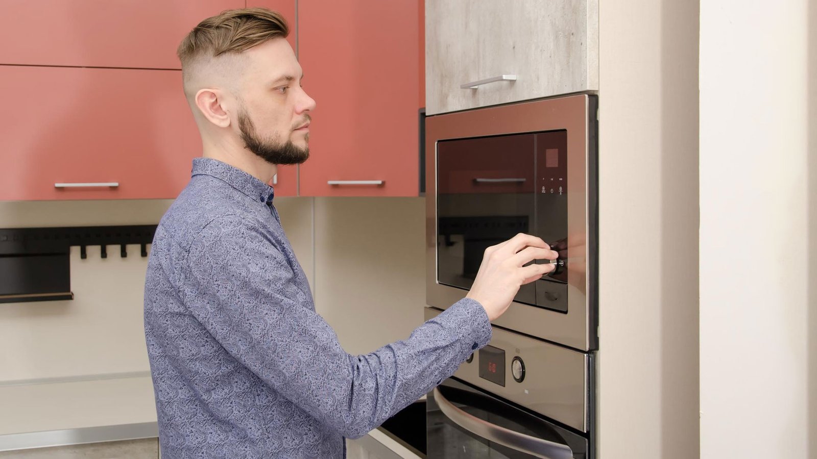 man using microwave oven