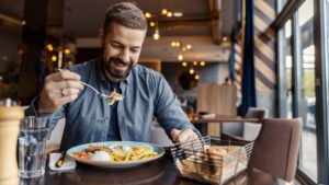 man eating at restaurant