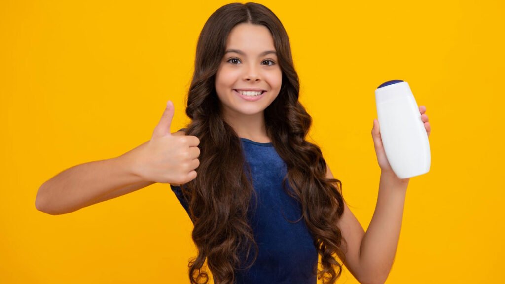 girl with beautiful hairs holding a bottle of shampoo